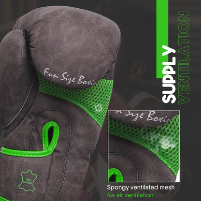 Close-up of light brown youth boxing glove with green ventilated mesh for airflow, reinforced wrist design, and padded protection for young boxers.